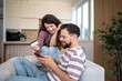 © Migma_Agency - Happy couple shopping online using credit card and smartphone at home