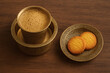 © GenAi - South Indian Filter Coffee served in Davara with Butter Cookies on Table