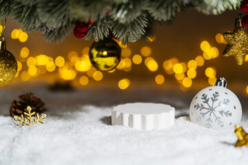 Wall Mural - christmas holiday background with snow, fir tree and decorations with christmas light behind. christ