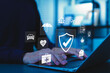 © Supatman - Insurance concept. A person using a laptop with various digital icons representing different types of insurance, such as health, home, car, travel, life, comprehensive coverage, and policy management.