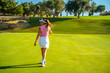 © unai - Golfer walking on golf course on sunny day