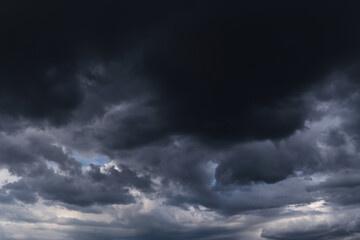 Wall Mural - Epic Dramatic Storm sky with dark black cumulus rainy clouds abstract background texture, thunderstorm