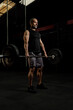 © Camilo - Muscular older Latino man with a barbell and weight plates doing an exercise routine, studio shot. Concept of exercise, gym, sports, health, and wellness.