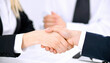 © Pixel Alchemist - Handshake between business people in formal suit showing agreement and cooperation in office environment with blurred background