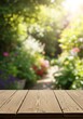 © Sujengkol - Sun-Kissed Garden Oasis: Rustic Wooden Plank Surface Overlooking a Lush Floral Escape