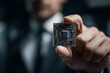 © AnggalihPs - Businessman holds up an advanced microchip with a close-up focus on the chip and his hand
