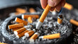 © Nayara - A closeup macro of an isolated cigarette butt and ash in an ashtray, a symbol of the unhealthy habit of smoking