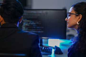 A diverse duo of AI developers in a pair programming session, analyzing a complex algorithm. A concept for teamwork, software engineering, and developing future technologies.