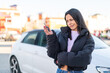 © luismolinero - Young woman at outdoors holding car keys at outdoors with sad expression