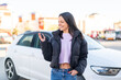 © luismolinero - Young woman at outdoors holding car keys at outdoors with happy expression