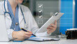 © NINENII - doctor woman using tablet to do online checklist survey, doing assessment online survey answer test questions Digital form.