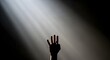 © StockShift - Silhouette of a hand with four fingers raised against dramatic light rays