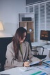 © Chanantida - Portrait of young Hispanic professional business woman standing in office. Happy female company executive, smiling businesswoman entrepreneur corporate leader manager looking at camera using tablet
