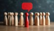 © miss irine - Conceptual image features red wooden figurine distinct from group of plain figures, with red speech bubble overhead. Represents individuality, unique ideas, and distinct opinions within collective.