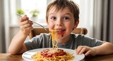 A young boy sitting at a table eating spaghetti with a fork