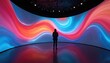 © miss irine - Woman stands before vivid digital art projection. Bright wavy colours, immersive experience in dimly lit space. Modern installation, futuristic design. Dynamic, interactive show, multimedia