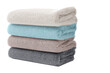 © Hub - Stack of soft, fluffy bath towels in various colors, isolated on white transparent background