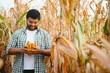 © Serhii - young indian farmer at corn field