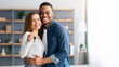 © Prostock-studio - Happy young multiracial couple holding home keys and hugging, romantic millennial family, black man and white woman poising in living room after moving to new appartment, smiling at camera, free space
