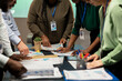 © DC Studio - Business consultants team meeting after hours to review diagrams and assess risks, exchanging feedback and collaborating on insights backed by business intel. Forecasting predictions.