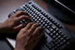 © Bloody 007 - Close up of a person s hands typing on a computer keyboard in a dimly lit room