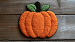 © Andres Mejia - Punch needle pumpkin decoration lying on rustic wooden table