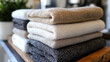 © Naruephu - Neatly folded linen towels stacked with calming tones and clean lines