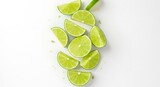Freshly Sliced Limes Arranged on White Background, Overhead View, Vibrant Green