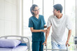 © Chanakon - Physical therapy. Female Nurse aids young man in recovering from spine injury and providing orthopedic massage Orthopedic healthcare and chiropractor with person for physical therapy rehabilitation