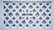 © Kropotkin - A white lattice design on a wall.