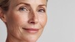 © Johannes - 50s middle aged old woman looking at camera isolated on white background advertising dry skin care treatment anti age skincare beauty plastic surgery cosmetology procedures close up half face view no
