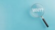 © J.G Studio - A magnifying glass focusing on the word why on a light blue colored background