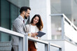 © Zoran Jesic - Business colleagues using tablet and discussing work outdoors