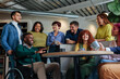 © bernardbodo - Diverse business team enjoying coffee break, discussing and smiling together
