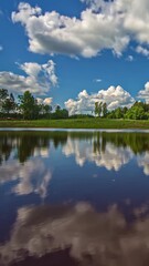 Wall Mural - Vertical View Of Serene Lake With Clouds Reflection. Timelapse