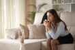 © Antonioguillem - Executive at home resting on a couch drinking coffee