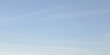 © sutthichai - Clean soft pale blue sky with very faint almost imperceptible wisps cirrus clouds. Sky smooth gradient shifting from slightly lighter shade bottom pastel blue top. Peaceful and calm background