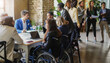 © DisobeyArt - Multiracial people working on business green energy project - Corporate, team meeting and disability concept - Focus on asian woman face