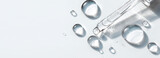 glass pipette with serum drop on light background with soft sunlight and shadows