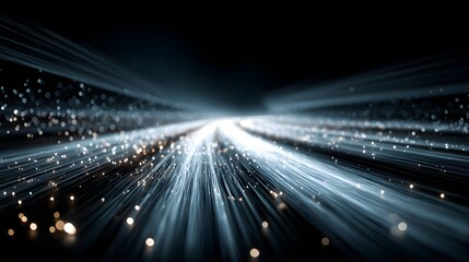 Abstract, futuristic photograph representing high-speed data transfer. Glowing blue lines of light and particles stream forward on a dark digital highway.