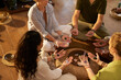 © Rido - Diverse people sitting in circle while practing healing crystal energy