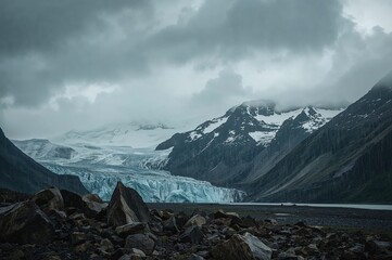 Wall Mural - Dreary weather with rugged cliffs and a towering snowy summit under persistent drizzle