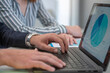 © GREGORIO - Business colleagues analyzing charts on laptop in office meeting