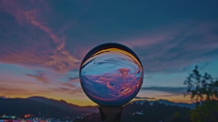 Wall Mural - Time lapse View of colorful nature at sunset inside crystal balls.
beautiful cloud in sky over sea in a crystal ball on the beach. 
Nature High quality footage in nature and travel concept.