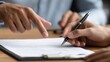 © Adi - Hand Pointing at Document Being Signed