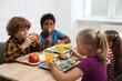 © New Africa - Little kids eating lunch at wooden table in school canteen