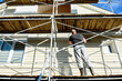 © Natallia - Cleaning the vinyl siding wall with a high-pressure washer.