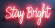 © antishock - Bright pink neon sign displays Stay Bright against dark background. Simple typography, positive message, modern aesthetic.