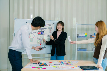 a team of developers collaborates to plan uxui designs, working on wireframes for website and mobile