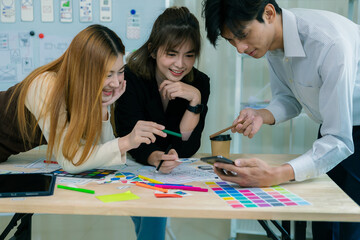 a team of developers collaborates to plan uxui designs, working on wireframes for website and mobile